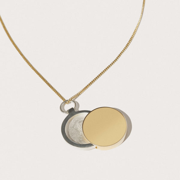 LARGE GOLD AND SILVER ECLIPSE LOCKET