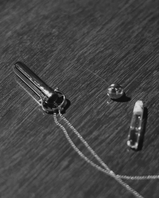 silver perfume vial on table 